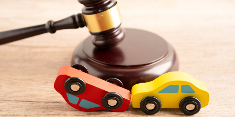 Car accident lawsuit and insurance, Judge hammer with car model.